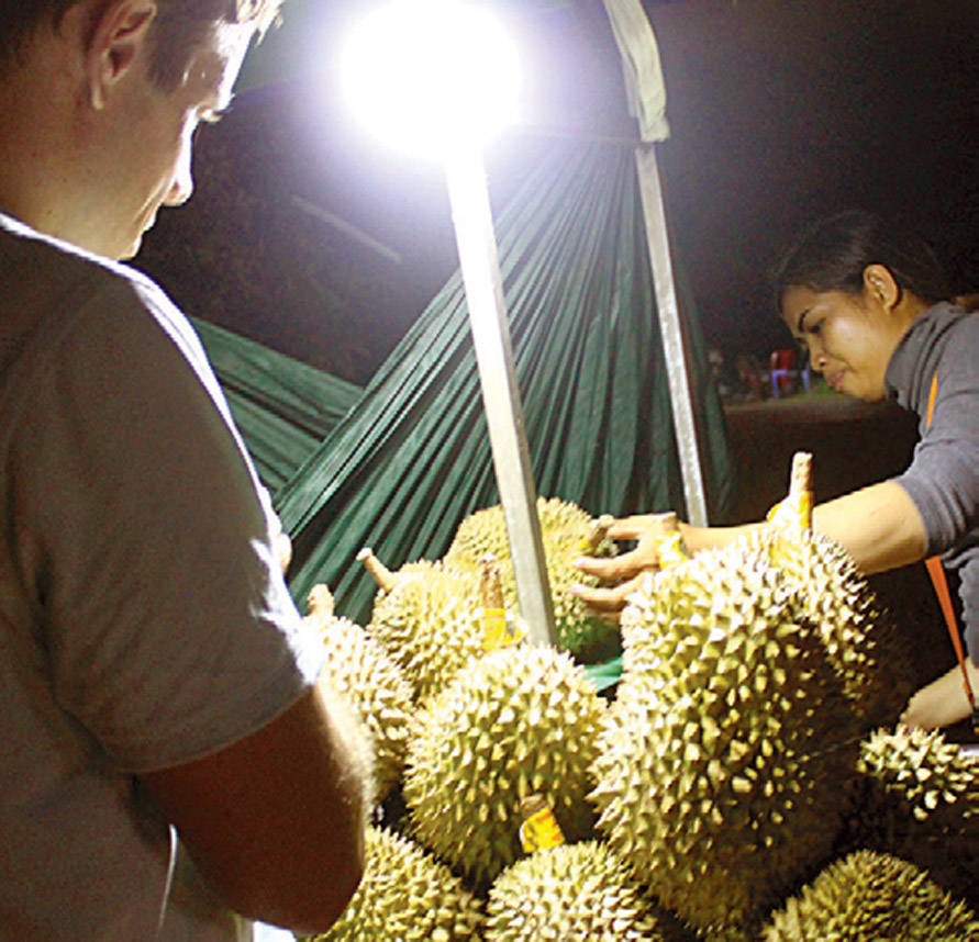 Steven Halcrow inspects durians