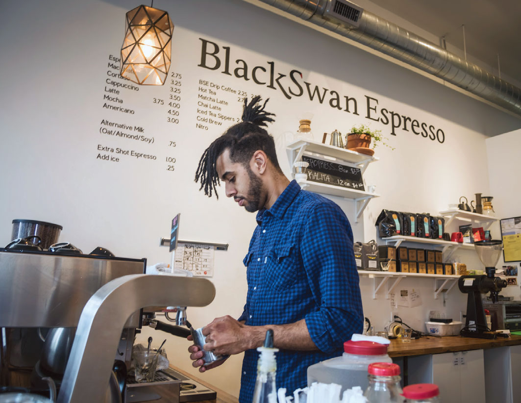 Manager Adam Bergo makes a latte at Black Swan Espresso