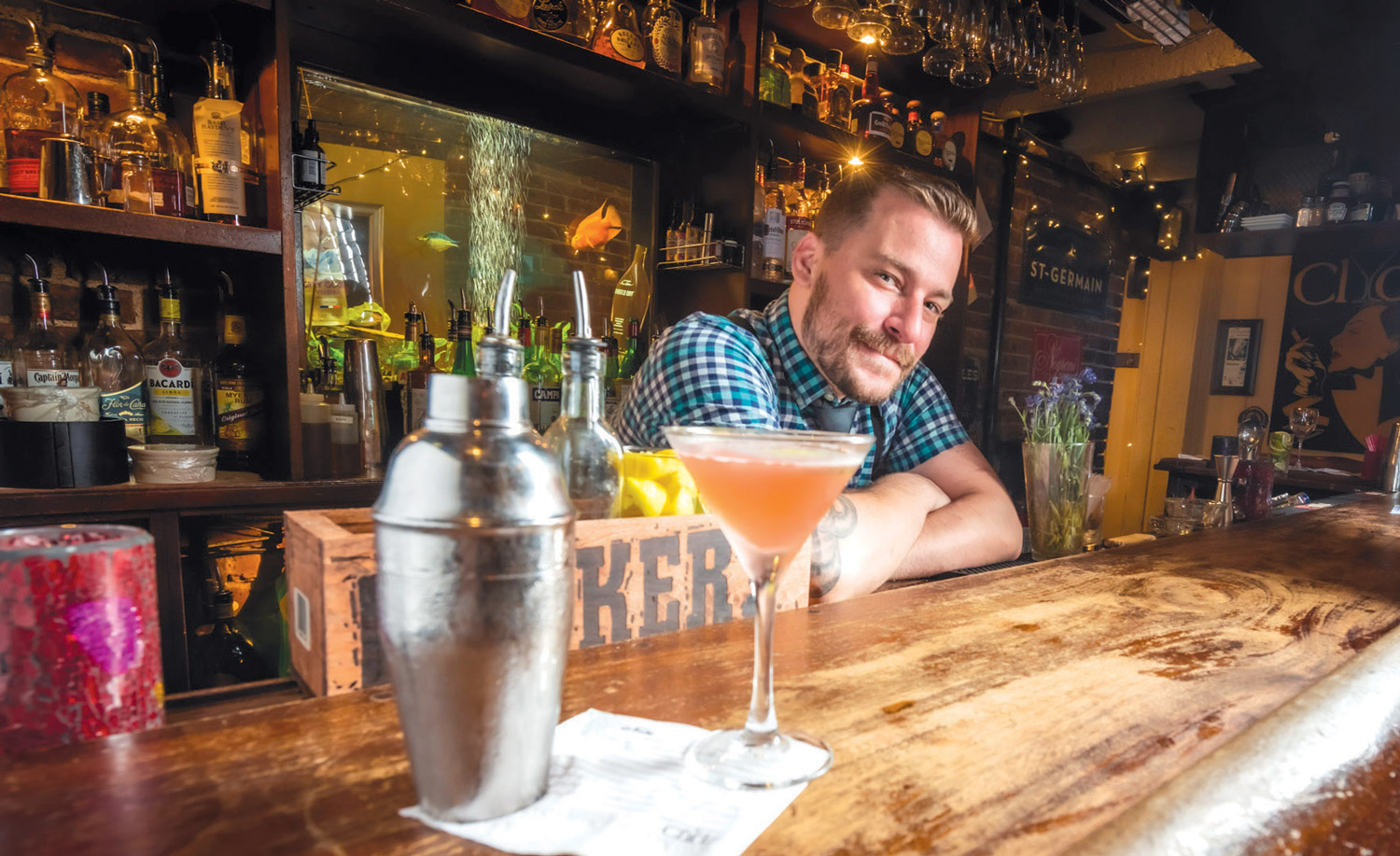 Bartender Kyle Burton prepares a “Holiday Inn” cocktail at Clydz restaurant,