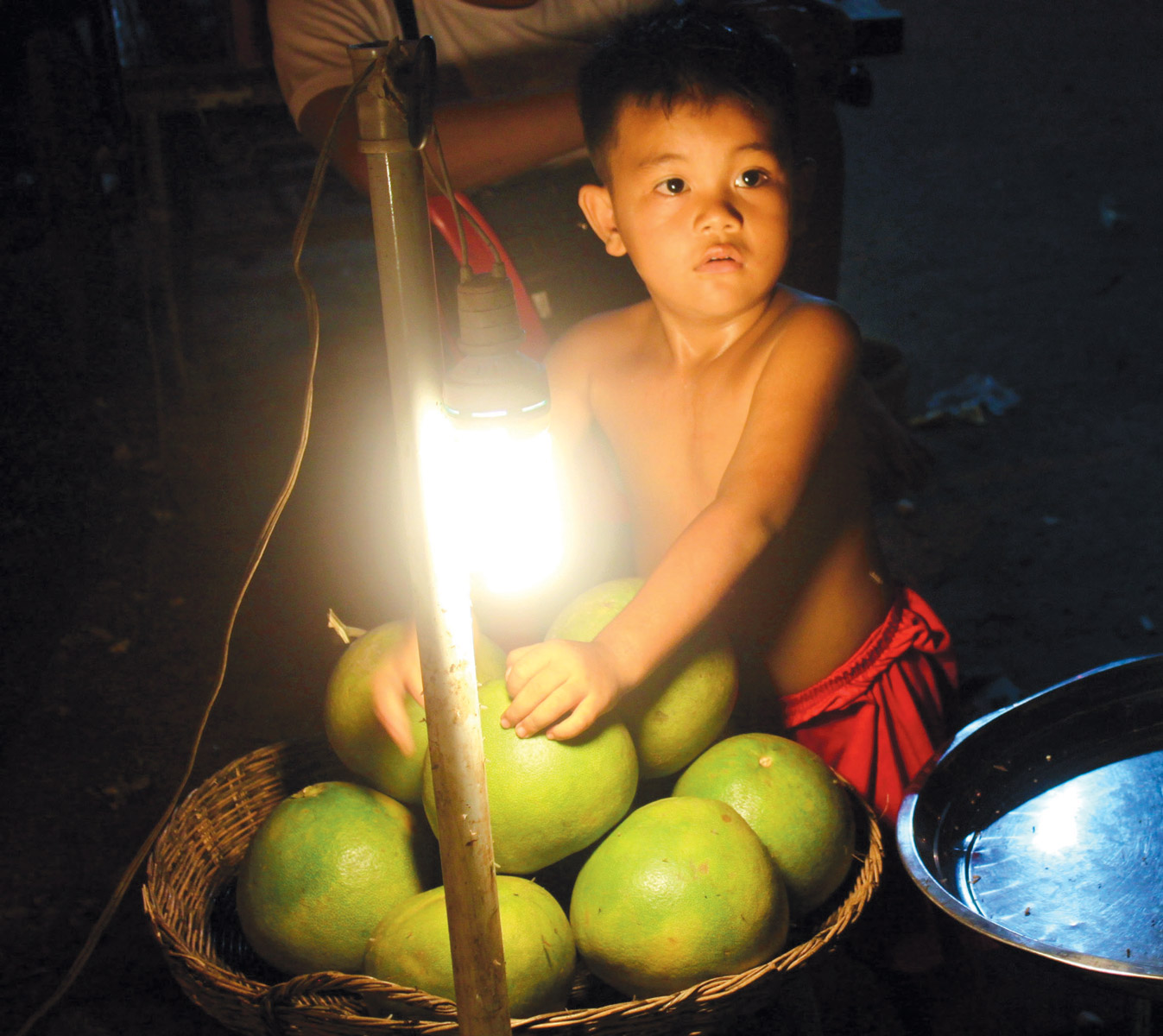 Fruit vendor’s child at the Siem Reap night market