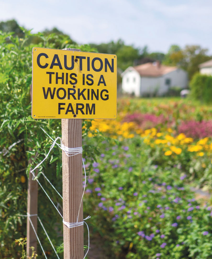 "Caution this is a working farm" sign