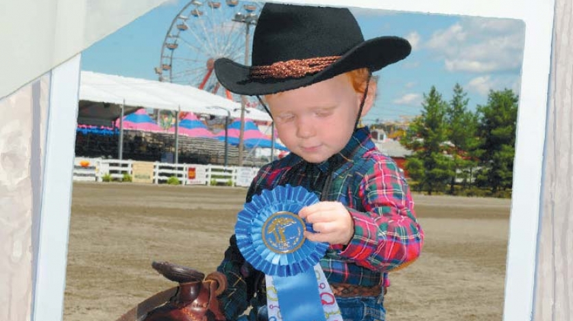 Boy holding a ribbon at New Jersey State Fair