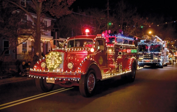 Holiday Parade - old fashioned fire engine wieathed in Christmas lights