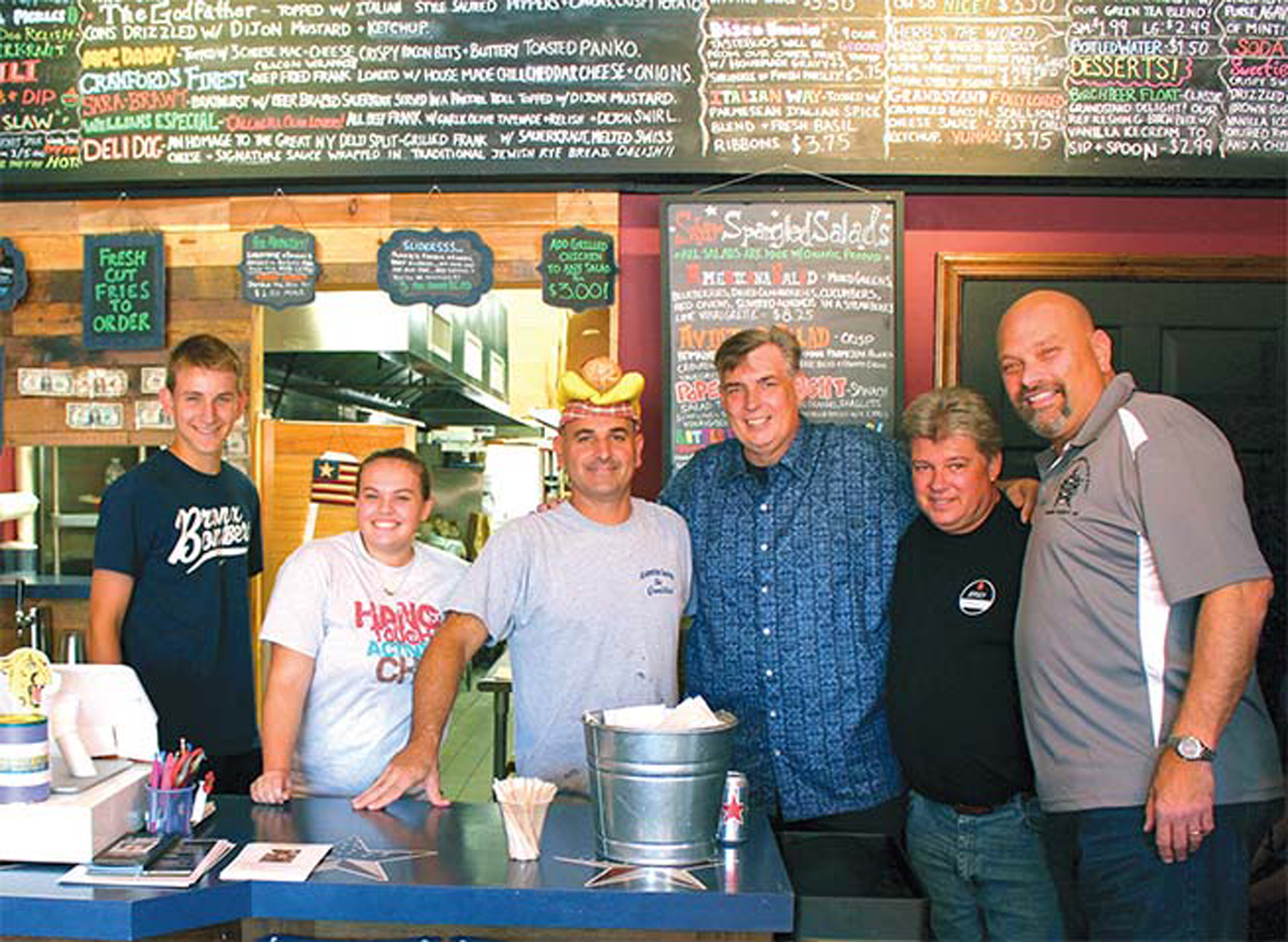 Benz, Fox and Ferigno pose with the owner and staff of The Grandstand