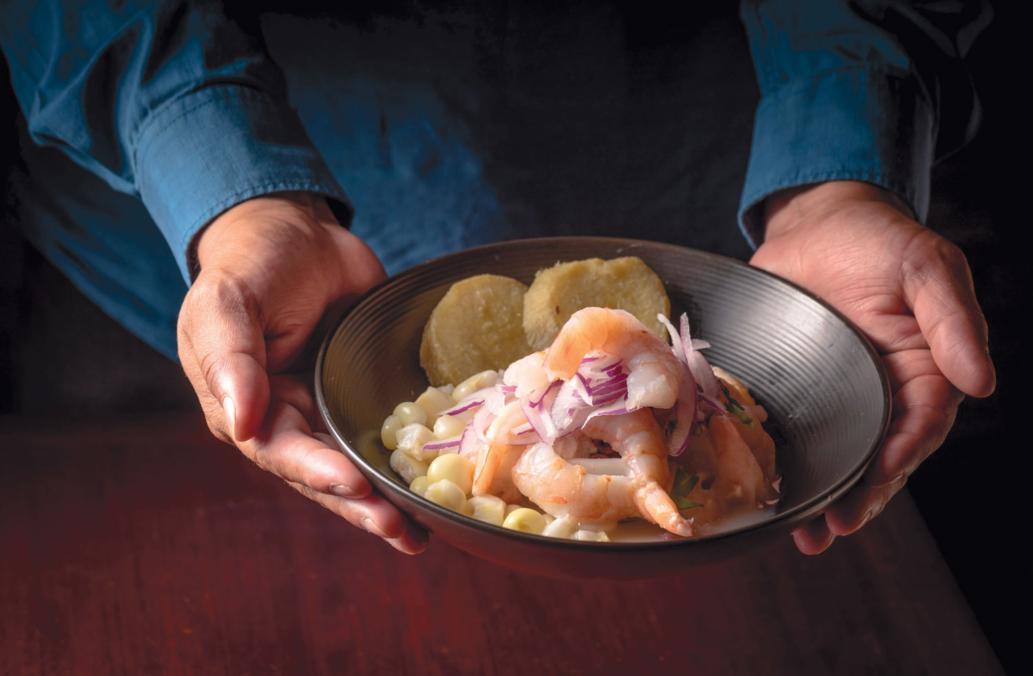 chef holding bowl of ceviche