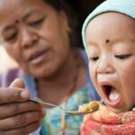 mom feeding child